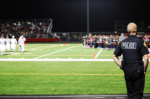 Photograph of Police in Football game by Jennifer Kaplan