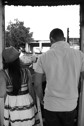 Photgraph of man and woman looking into ruins